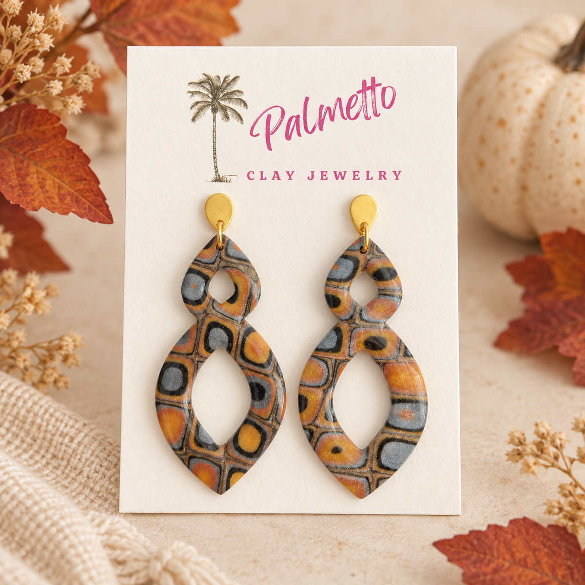 Hearthside metallic polymer clay earrings with a retro geometric pattern in copper, black, gold and silver with gold-tone tops