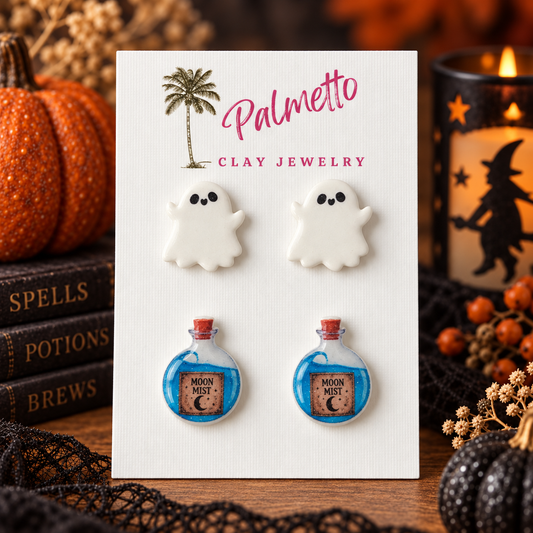 Two-pair Halloween stud earring set with white ghost earrings and blue Moon Mist potion bottle earrings on a Palmetto Clay Jewelry card.